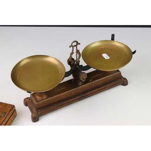 98 - A set of early 20th century balance scales together with a cased set of brass weights.