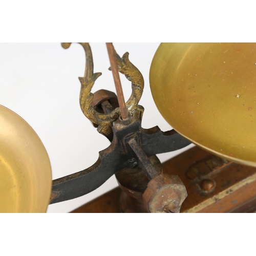 98 - A set of early 20th century balance scales together with a cased set of brass weights.