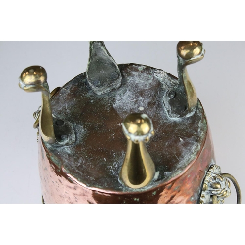 102 - Copper Circular Planter with two brass ringed lion mask handles and raised on four tall brass lion p... 