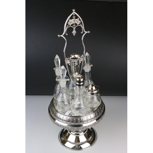 106 - An antique silver plated cruet / condiment centre piece with decorative etched glass bottles.