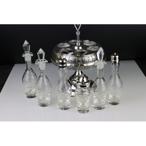106 - An antique silver plated cruet / condiment centre piece with decorative etched glass bottles.