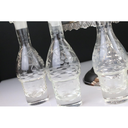 106 - An antique silver plated cruet / condiment centre piece with decorative etched glass bottles.