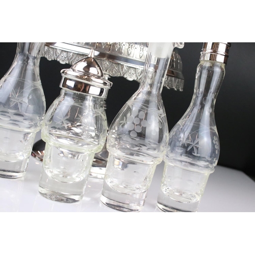 106 - An antique silver plated cruet / condiment centre piece with decorative etched glass bottles.
