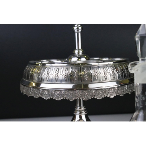 106 - An antique silver plated cruet / condiment centre piece with decorative etched glass bottles.