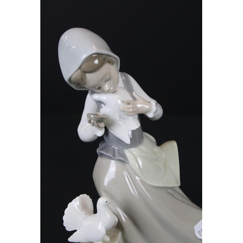 42 - Two Lladro Girls, one with two geese and the other with two doves, tallest 28cm high