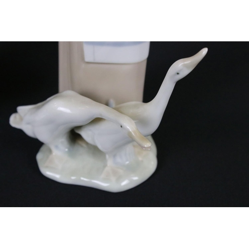 42 - Two Lladro Girls, one with two geese and the other with two doves, tallest 28cm high
