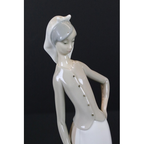 42 - Two Lladro Girls, one with two geese and the other with two doves, tallest 28cm high