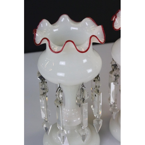 7 - Pair of Late Victorian Opaque Glass Table Lustres with red glass wavy rims, each with eight crystal ... 