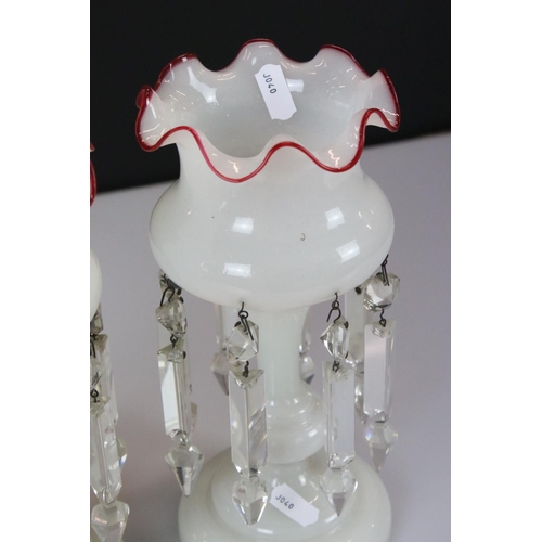 7 - Pair of Late Victorian Opaque Glass Table Lustres with red glass wavy rims, each with eight crystal ... 