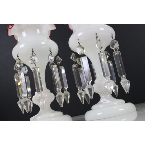 7 - Pair of Late Victorian Opaque Glass Table Lustres with red glass wavy rims, each with eight crystal ... 