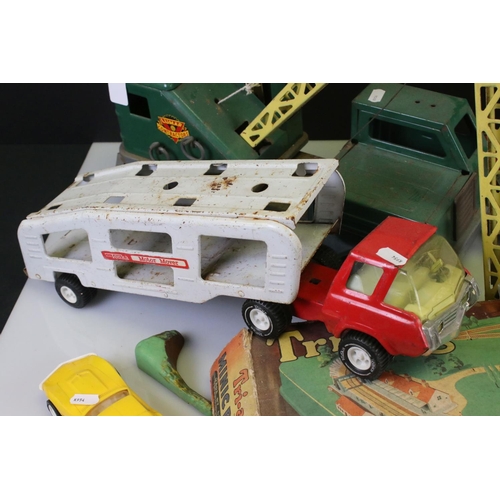 486 - Four large tin plate model toys to include Triang truck, Tonka Motor Mover, Marx High Lift Mobile Cr... 