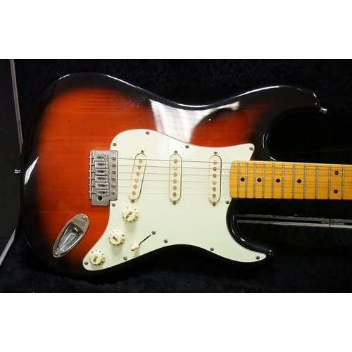 600 - Guitar - A stratocaster style electric guitar with Fender decals to headstock, in a Fender branded h... 