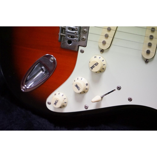 600 - Guitar - A stratocaster style electric guitar with Fender decals to headstock, in a Fender branded h... 