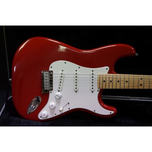 601 - Guitar - A 1980's Fender Stratocaster made in the USA, red finish.  With Fender hardcase and strap. ... 