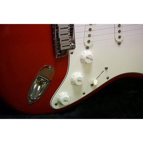 601 - Guitar - A 1980's Fender Stratocaster made in the USA, red finish.  With Fender hardcase and strap. ... 