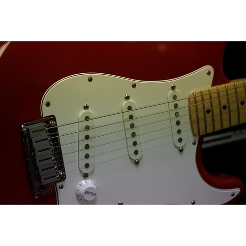 601 - Guitar - A 1980's Fender Stratocaster made in the USA, red finish.  With Fender hardcase and strap. ... 