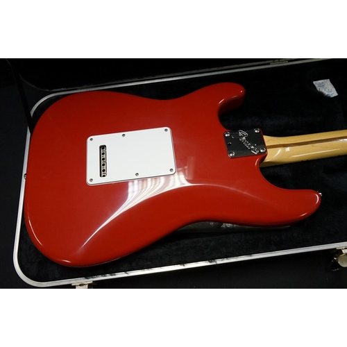 601 - Guitar - A 1980's Fender Stratocaster made in the USA, red finish.  With Fender hardcase and strap. ... 