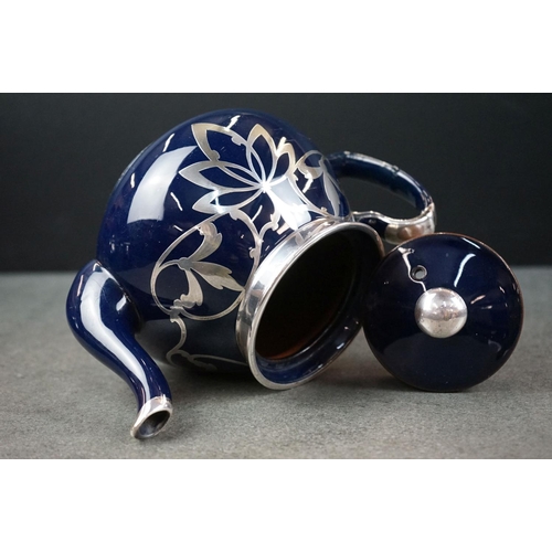 28 - Blue Glazed Pottery Tea Service comprising Teapot, Lidded Sugar and Milk Jug, with white metal overl... 