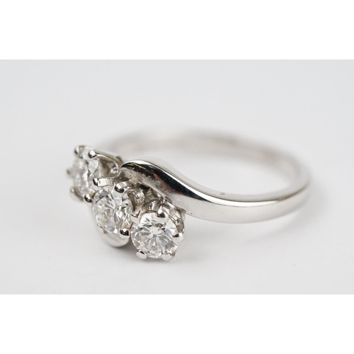 341 - Diamond 18ct white gold three stone crossover ring, three round brilliant cut diamonds, total stated... 