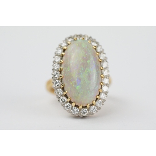 20 - Opal and diamond 18ct yellow gold and white gold set cluster ring, the large oval cabochon cut preci... 