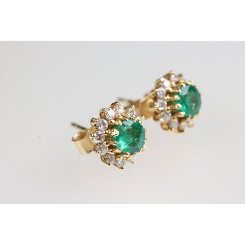 35 - Emerald and diamond 18ct yellow gold cluster earrings, the round mixed cut emerald measuring approx ... 