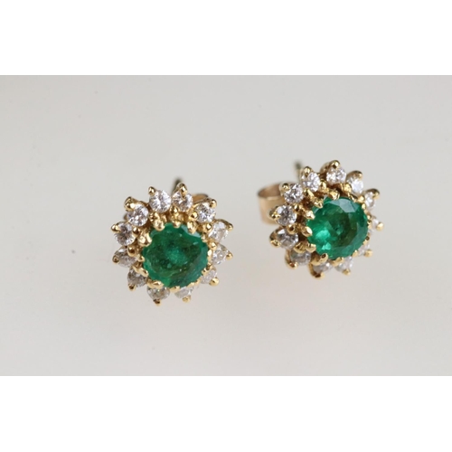 35 - Emerald and diamond 18ct yellow gold cluster earrings, the round mixed cut emerald measuring approx ... 