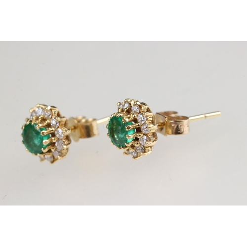 35 - Emerald and diamond 18ct yellow gold cluster earrings, the round mixed cut emerald measuring approx ... 