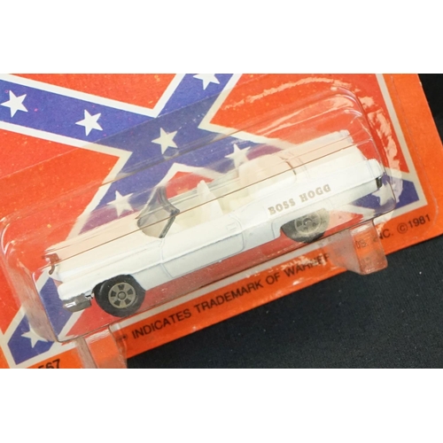 394 - Two carded ERTL Dukes of Hazard diecast models to include General Lee and Boss Hogg's Cadillac (unpu... 