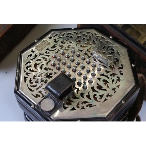 123 - An English Wheatstone & Co concertina, with fifty six metal buttons on foliate pierced metal, No.276... 