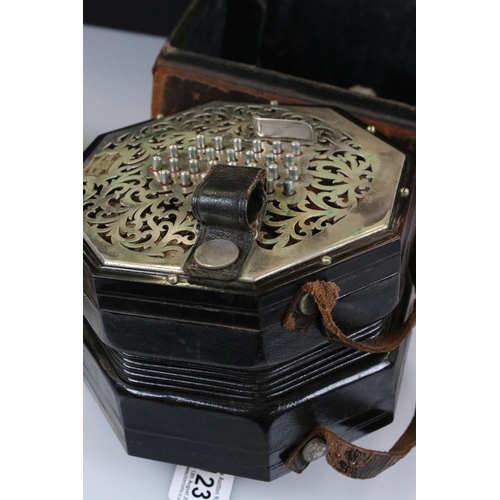 123 - An English Wheatstone & Co concertina, with fifty six metal buttons on foliate pierced metal, No.276... 