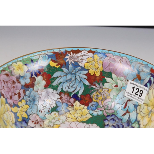 129 - An oriental copper bowl with floral cloisonné decoration.