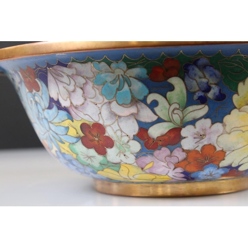 129 - An oriental copper bowl with floral cloisonné decoration.