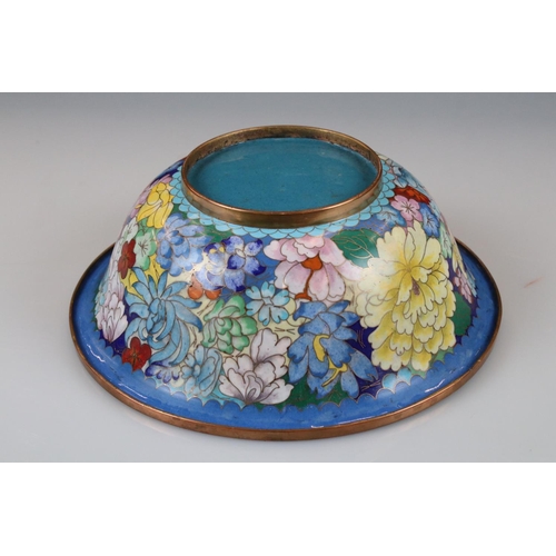 129 - An oriental copper bowl with floral cloisonné decoration.