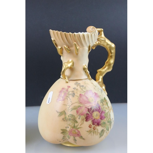 13 - Pair of Royal Worcester Blush Ivory Jugs, decorated with flowers and with gilt moulded handles in th... 