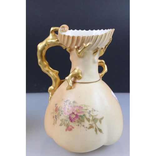 13 - Pair of Royal Worcester Blush Ivory Jugs, decorated with flowers and with gilt moulded handles in th... 