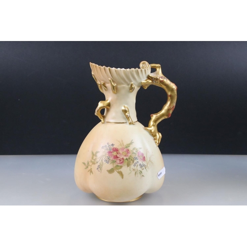 13 - Pair of Royal Worcester Blush Ivory Jugs, decorated with flowers and with gilt moulded handles in th... 