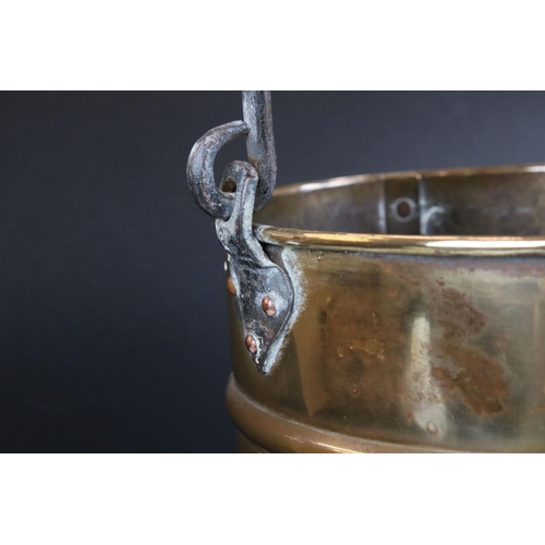 138 - A ribbed brass coal bucket with wrought iron handle.