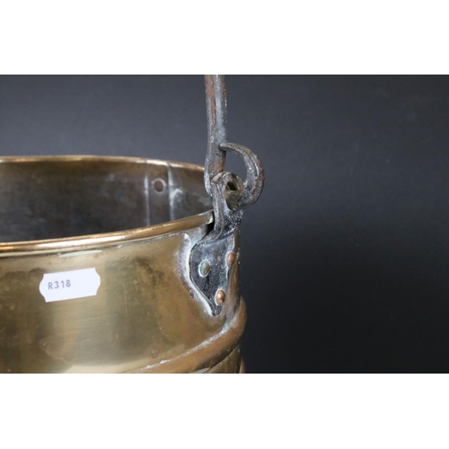 138 - A ribbed brass coal bucket with wrought iron handle.