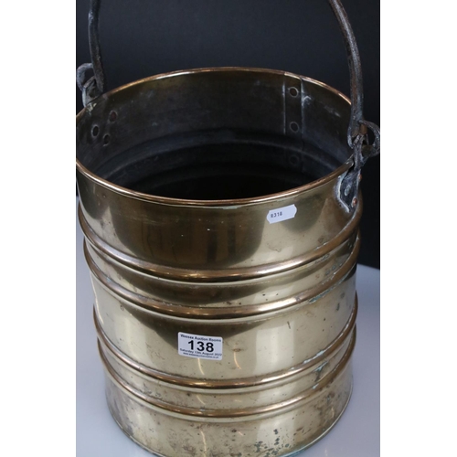 138 - A ribbed brass coal bucket with wrought iron handle.