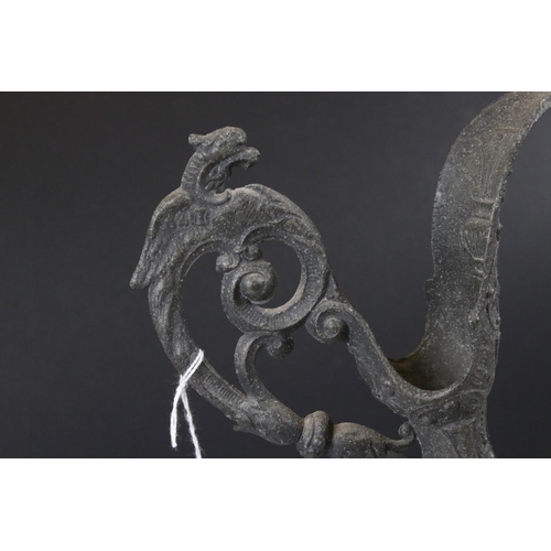 141 - A victorian door knocker of classical form together with a cast metal ewer.