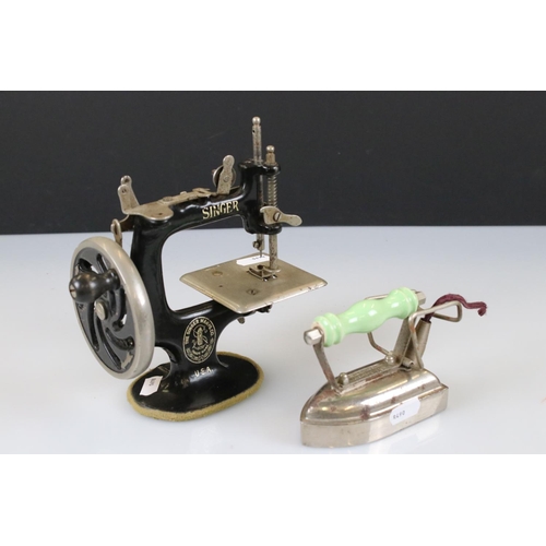 145 - An antique cast iron miniature Singer sewing machine together with a miniature A.R.C. Chesterton iro... 