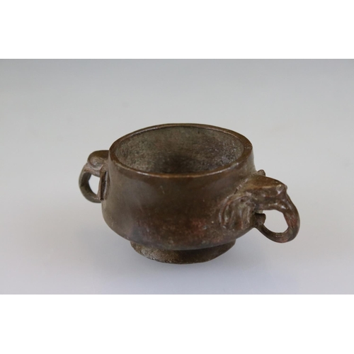 164 - Bronze footed bowl with elephant head handles, signed with character marks to underside, approx. dia... 