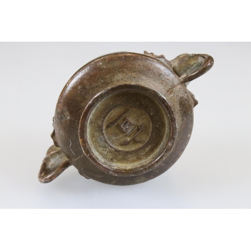 164 - Bronze footed bowl with elephant head handles, signed with character marks to underside, approx. dia... 