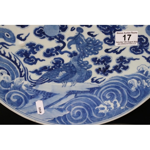 17 - Chinese Blue and White Charger decorated with Dragon and Mythical Birds chasing a pearl amongst clou... 