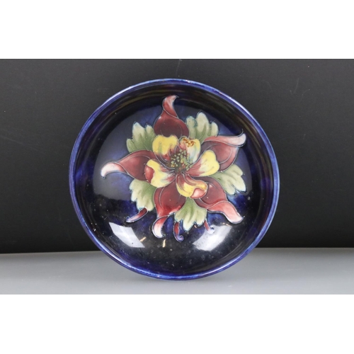 2 - Moorcroft Pottery Bowl decorated in the columbine pattern on a blue ground, label to base, 14cm diam... 