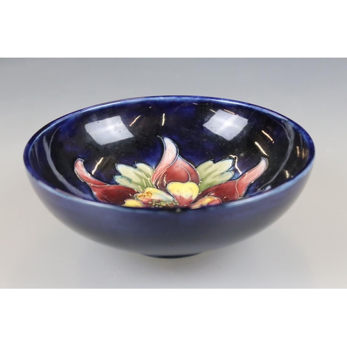 2 - Moorcroft Pottery Bowl decorated in the columbine pattern on a blue ground, label to base, 14cm diam... 