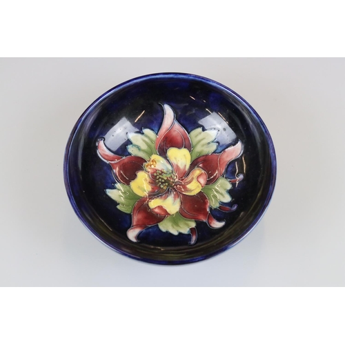 2 - Moorcroft Pottery Bowl decorated in the columbine pattern on a blue ground, label to base, 14cm diam... 