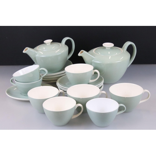 23 - Poole Pottery Cameo Celadon part Tea Service comprising two teapots, eight cups, eleven saucers and ... 