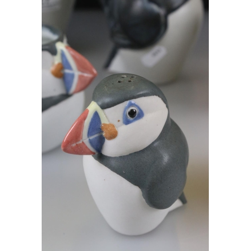 27 - John O'Groats Pottery - Set of Three Graduating Puffin Jugs, largest 20cm high together with another... 