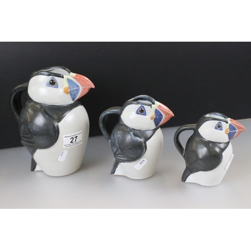 27 - John O'Groats Pottery - Set of Three Graduating Puffin Jugs, largest 20cm high together with another... 